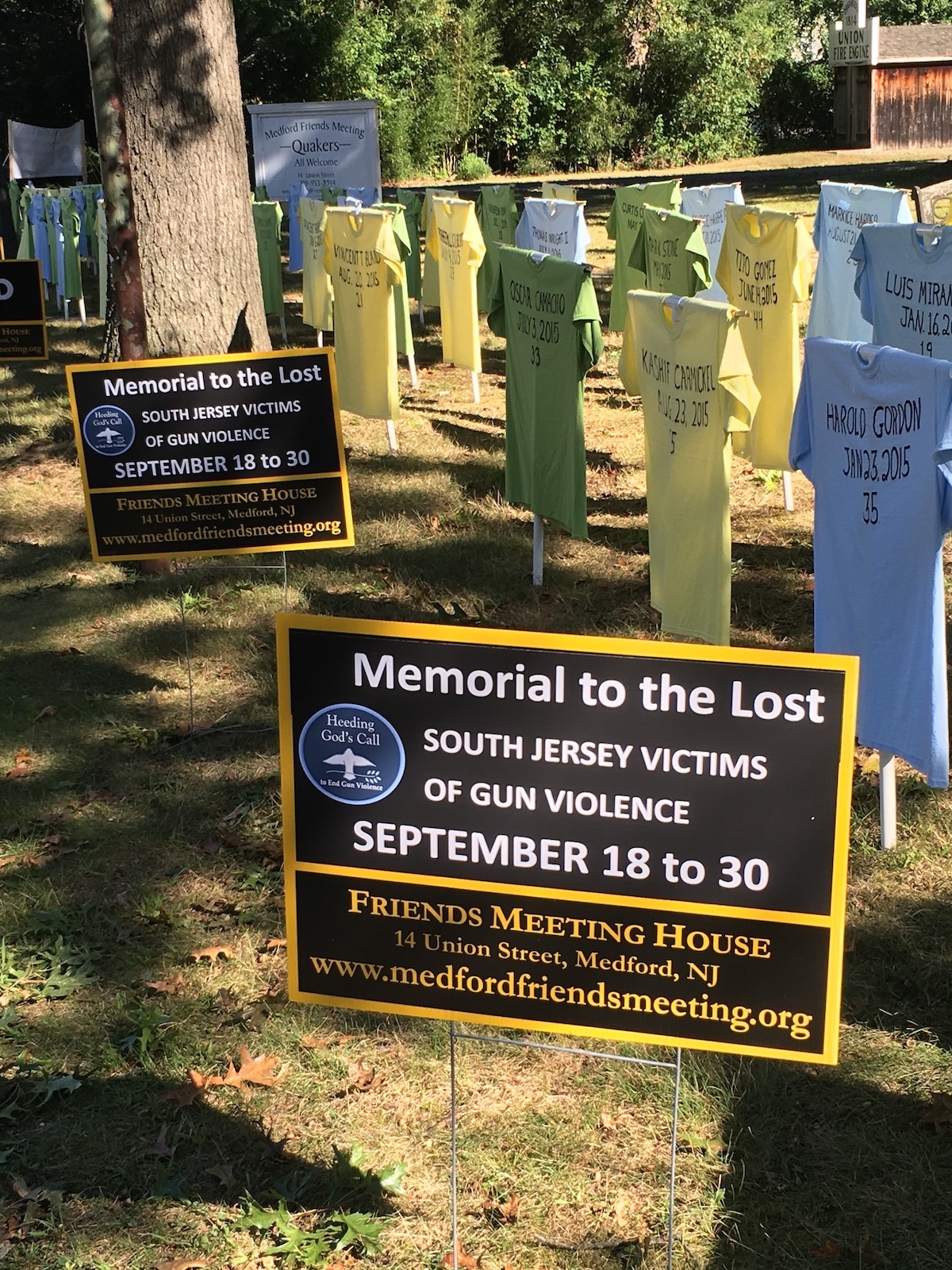 t-shirts stand up in a field as a memorial to those lost to gun violence